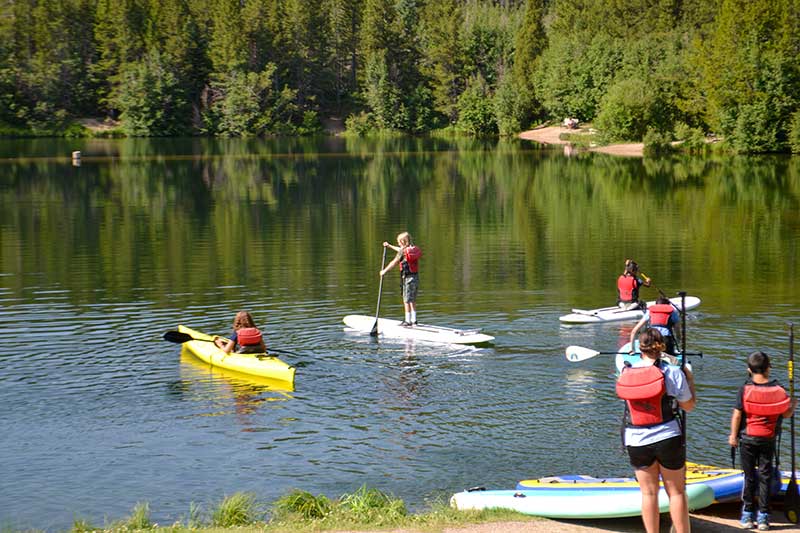 Wilderness Camp participants try their hand at kayaking and SUPing
