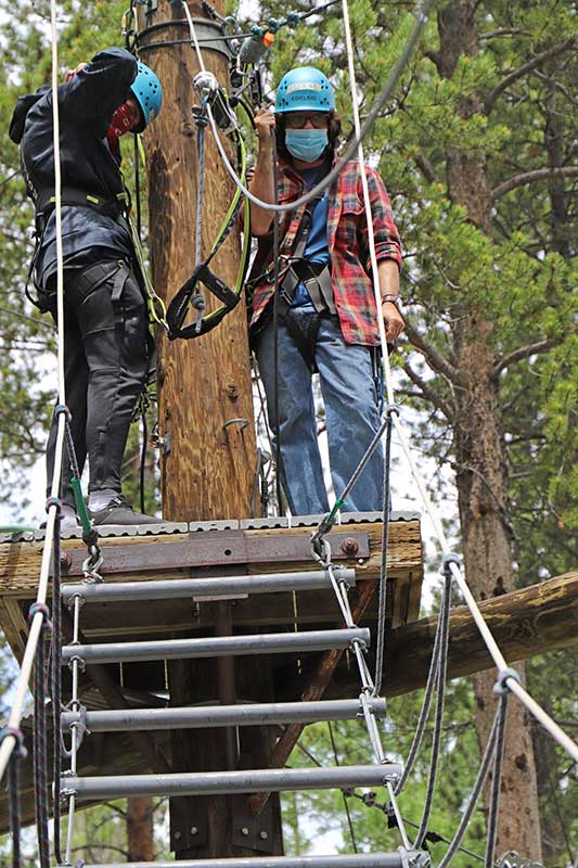 Steve readies a participant for a ropes course challenge