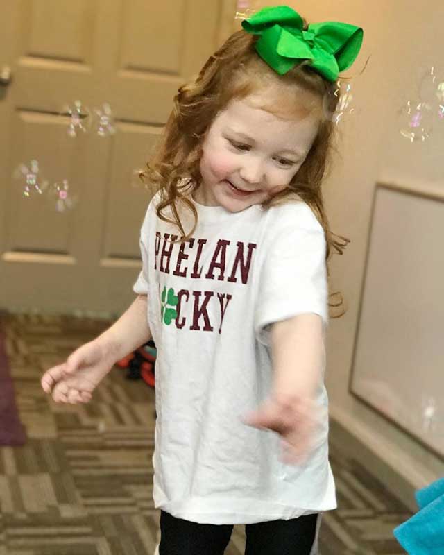 Cecilia wears a t-shirt supporting Phlean-McDermid syndrome