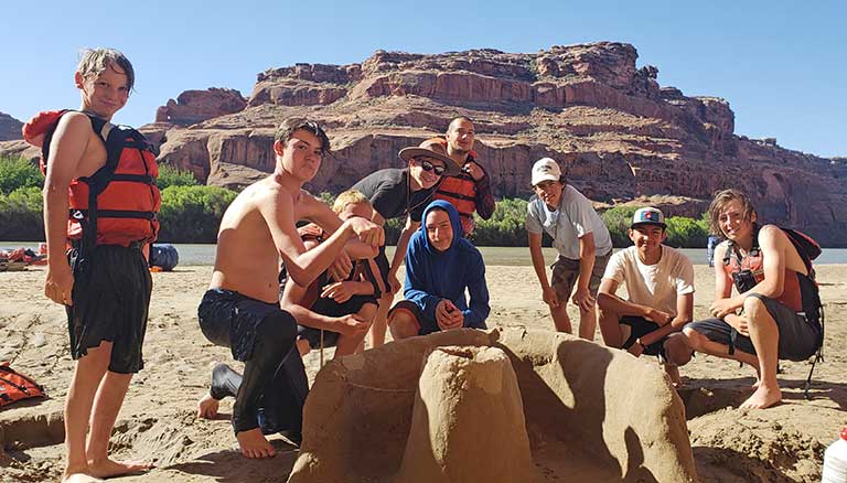 A boys SOAP group poses along the banks of the Green River