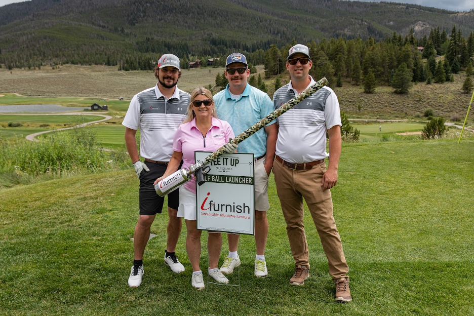 Pictured is Co-Owner of iFurnish, Kelly Pestello, and sons try their hand at the ifurnish golf ball launcher