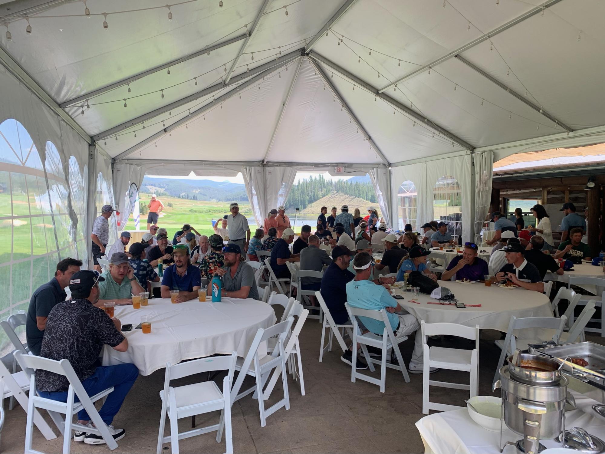 Golfers enjoying food and drinks at the 19th Hole After Party.