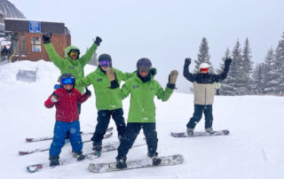 Carlos, co-instructors, and SSA participants are all smiles on a snowy Sunday.